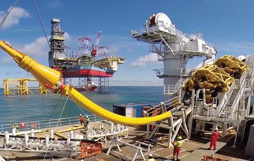 Cable laying vessel NKT Victoria installing an offshore cable with platform Martin Linge in the background