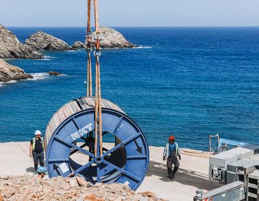 Workers with a drum onshore