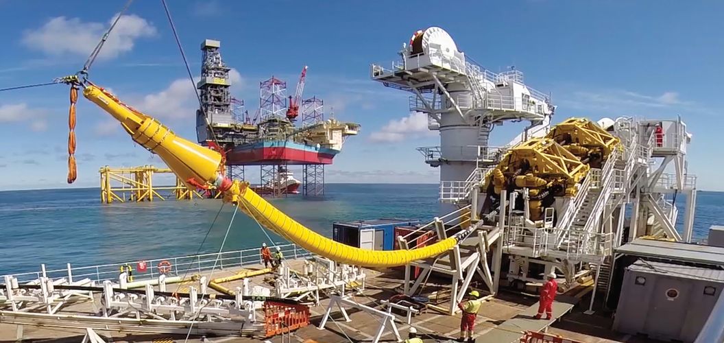 Cable laying vessel NKT Victoria installing an offshore cable with platform Martin Linge in the background