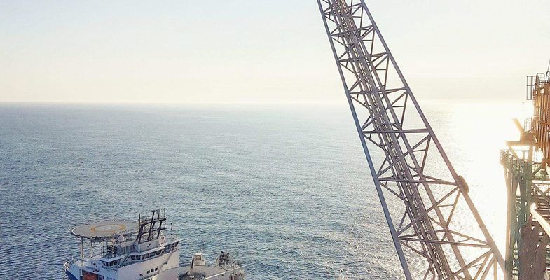 Cable laying vessel in front of platform Johan Sverdrup