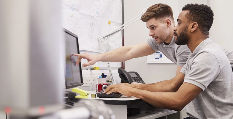 two young engineers working in front of computer