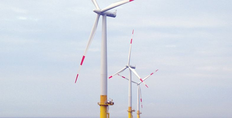 Three windmills at sea