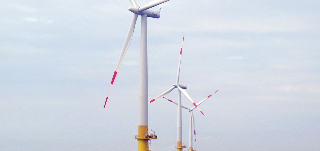 Three windmills at sea